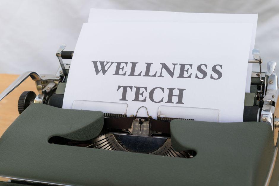 A Typewriter with the Word Wellness Tech on It